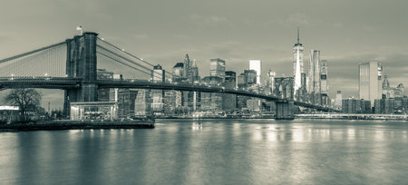 Panoramic view of  Brooklyn Bridge and Manhattan skyline in New York City at morning with city...