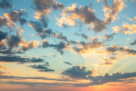 Sunrise sky - gentle colors of soft clouds and sunshine with rays, amazing real background for wallpaper, big sizeの写真素材