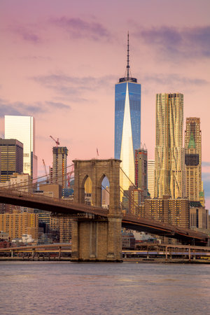 Morning colors of famous New York Landmarks - Brooklyn Bridge and  Manhattan offices skyline, New York City,  USAの写真素材