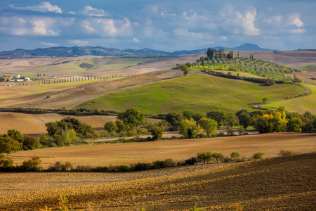 Aerial view of beautiful countryside valley - hills, trees, fields, sunny weather and blue sky. Tuscany nature, Italy, Europeのeditorial素材