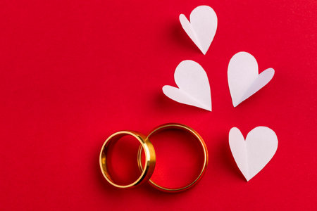 Love  background - two gold wedding rings and handmade hearts design, celebration cardの写真素材