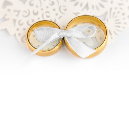 White Wedding Celebration background - pair of wedding rings with bow and copy space for textの写真素材