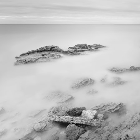 Long exposure sea artistic landscape. Light, water and stones perspective. Black and whiteの写真素材