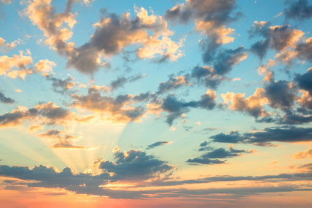 Sunshine Sunrise sky - gentle colors of soft clouds and sunshine with rays, amazing real background for wallpaper, big sizeの写真素材