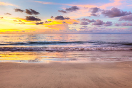 Beautiful sunset sunrise sky, cloud and ocean reflections - colors of happiness and restの写真素材
