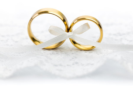 Light Wedding Celebration background - pair of wedding rings with bowの写真素材
