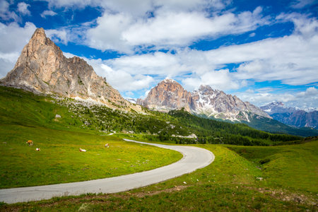 Mountain green valley landscape with road, summer day in Dolomites Alpsの写真素材