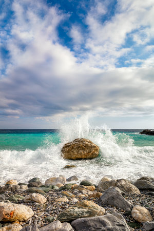 Big Wave hit the stone at beach, sea water splash up to the sky. Morning at Sea. Storm. Seascape.の写真素材