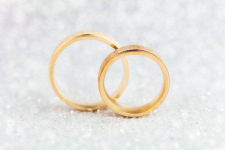 Sparkling Wedding Card Gentle light Background - Two Wedding Rings on real glitter bokehの写真素材