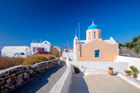 Famous greek church architecture in Oia town cityscape at Santorini island in Greece. Traditional white houses. Greece, Aegean sea. Famous European destinationの写真素材