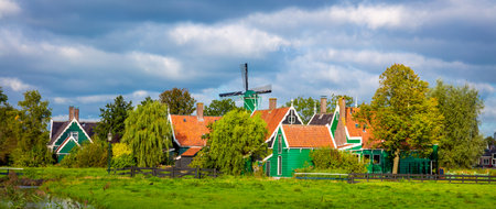 Panoramic view of the Dutch village Zaanse Schans near Amsterdam. Typical Dutch green houses and windmills. Holland, Netherlandsの写真素材