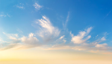 Background of Light cirrus clouds in the blue sky during dawn sunsetの写真素材