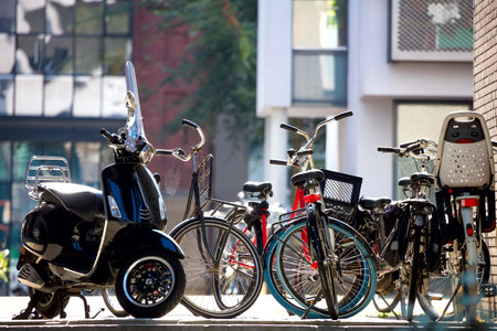 Urban fragment - parked bicycles against the background of residential buildings. Beautiful morning light. Focus on the foreground. Urban Life of a Modern European City. Amsterdam, Holland, Europeの写真素材