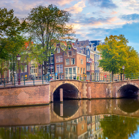 Amsterdam Downtown. Beautiful sky at sunrise, old leaning houses, canals and bridges. Heart of Amsterdam. Amsterdam, Holland, Netherlands, Europeの写真素材