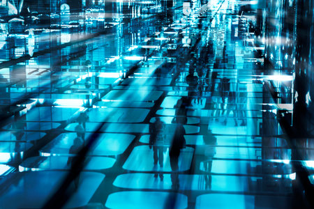 Abstract urban background - a crowd of people in a mirror space. Defocused. Conceptual blue city motion background. People as silhouettesの写真素材