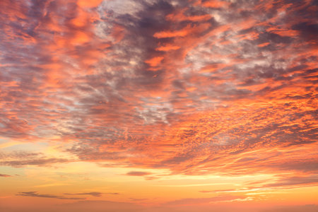 Awe dramatic clouds in orange sundown sky. Sunrise sunset sky backgroundの写真素材
