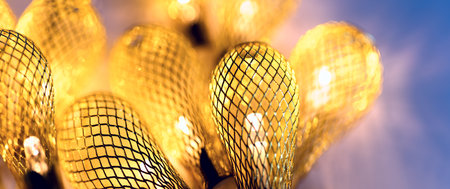 Panoramic holiday background - glowing retro light bulbs of golden garlands. Festive mood bannerの写真素材