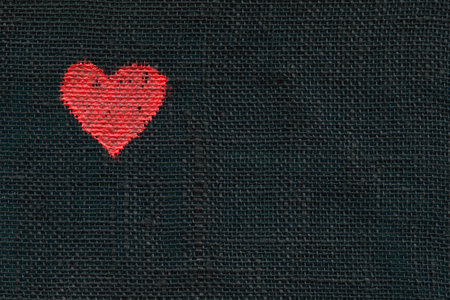 Handpainted heart symbol on a linen materialの写真素材