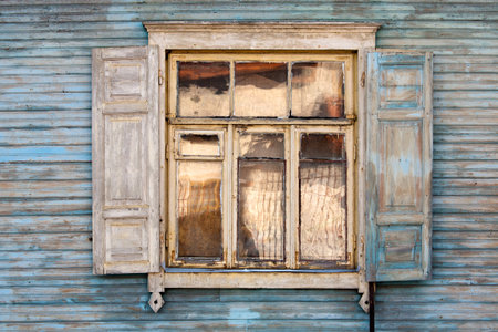 Old window on a blue wooden wallの写真素材