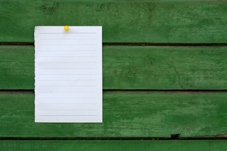 Close up of lined note paper on wooden background 