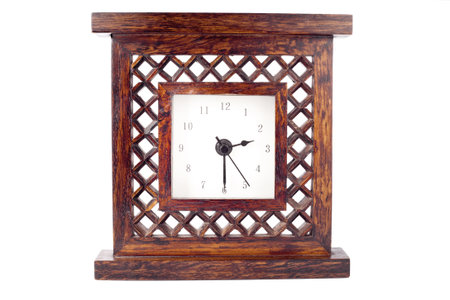 Clock in carved wood frame isolated on white