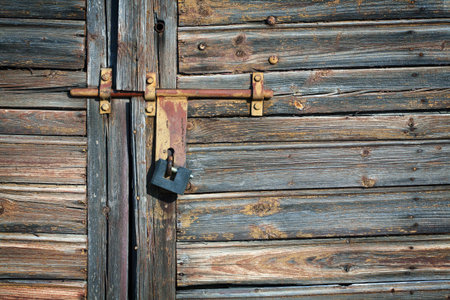 Old latch with padlock on doors の写真素材