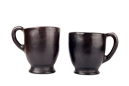 Two old handmade clay cups, isolated on whiteの写真素材