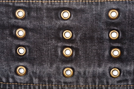 Worn black jeans texture with rivets