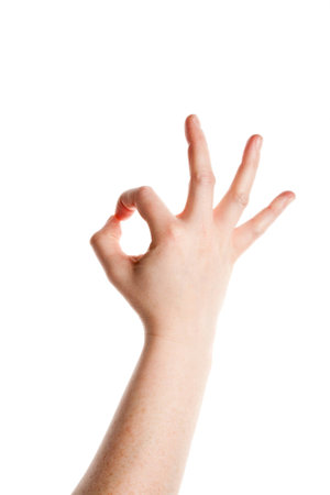 Woman's hand showing a gesture "ok"  isolated on a white background. の写真素材