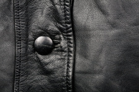 Black leather texture and a buttonの写真素材