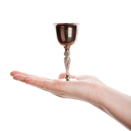 Female hand holding silver goblet isolated on white background  