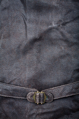 Fragment of suede vest back with metal buckle  の写真素材