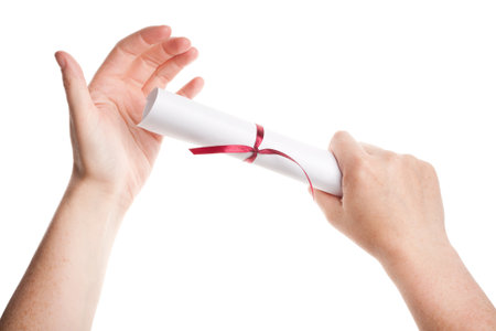 Graduation diploma in hands isolated on white の写真素材