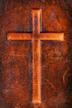 Cross symbol on a brown leather textureの写真素材