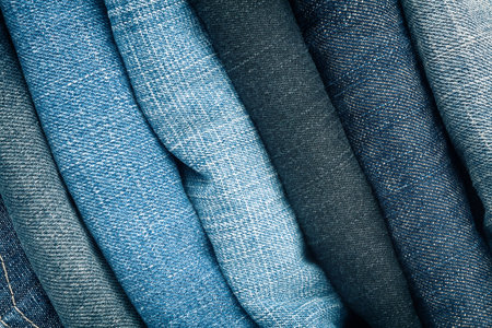 Stack of blue jeans as a background or texture  の写真素材