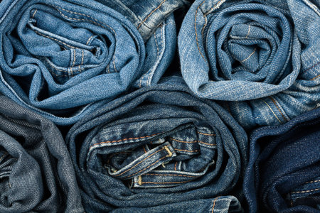 Stack of blue jeans as a background or texture  の写真素材