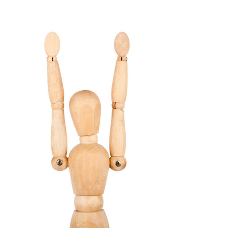 Wooden dummy with raised hands isolated on a white background の写真素材