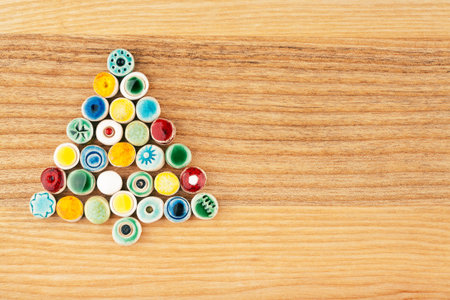 Colorful fir made from ceramic beads on wood textureの写真素材