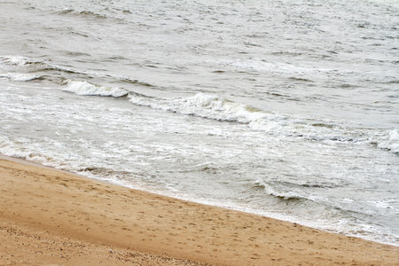 Soft waves of the sea on the sandy beach 