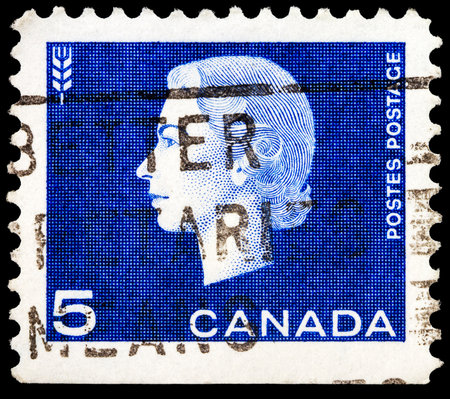 CANADA - CIRCA 1962: A stamp printed in Canada shows a portrait of Queen Elizabeth II and wheat as agriculture symbol, circa 1962. のeditorial素材