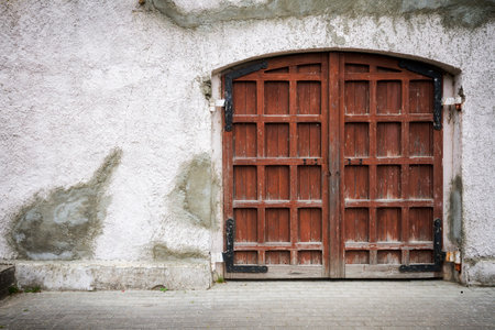 Old wooden gate in grungy gray wall