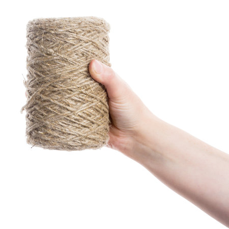 Hand holding hank of twine isolated on white  