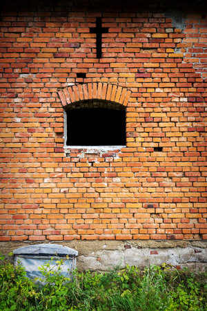 Red brick wall background with cross over windowの写真素材