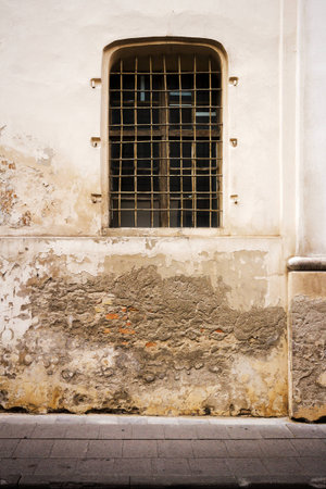 Old cracked wall with a window   