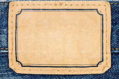 Blank leather jeans label sewed on a blue jeans 