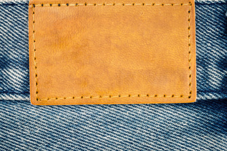 Blank leather jeans label sewed on a blue jeans.の写真素材