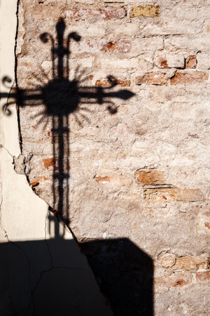 Shadow of a cross on a wallの写真素材