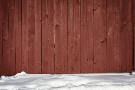 Brown wooden fence in snowの写真素材