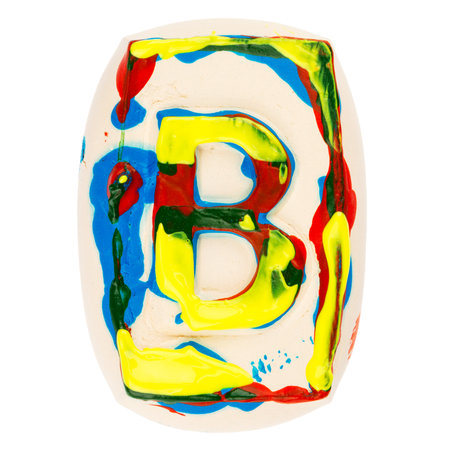 Handmade of white clay letter B painted with colorful acrylic paints isolated on whiteの写真素材