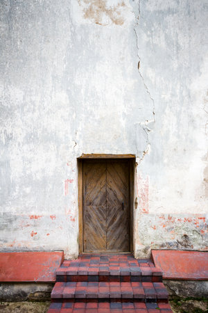 Old wooden door and stone stepsの写真素材